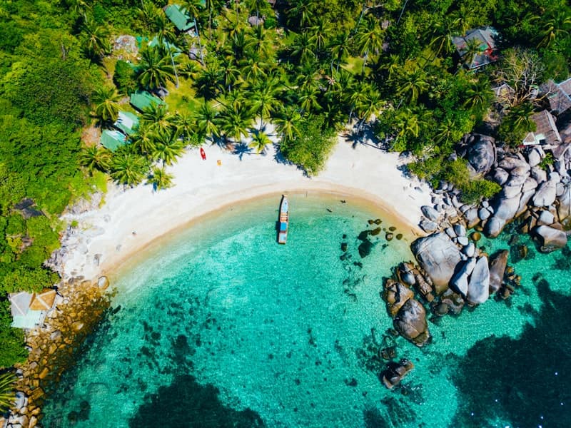 Aerial view of a turquoise bay and white sand